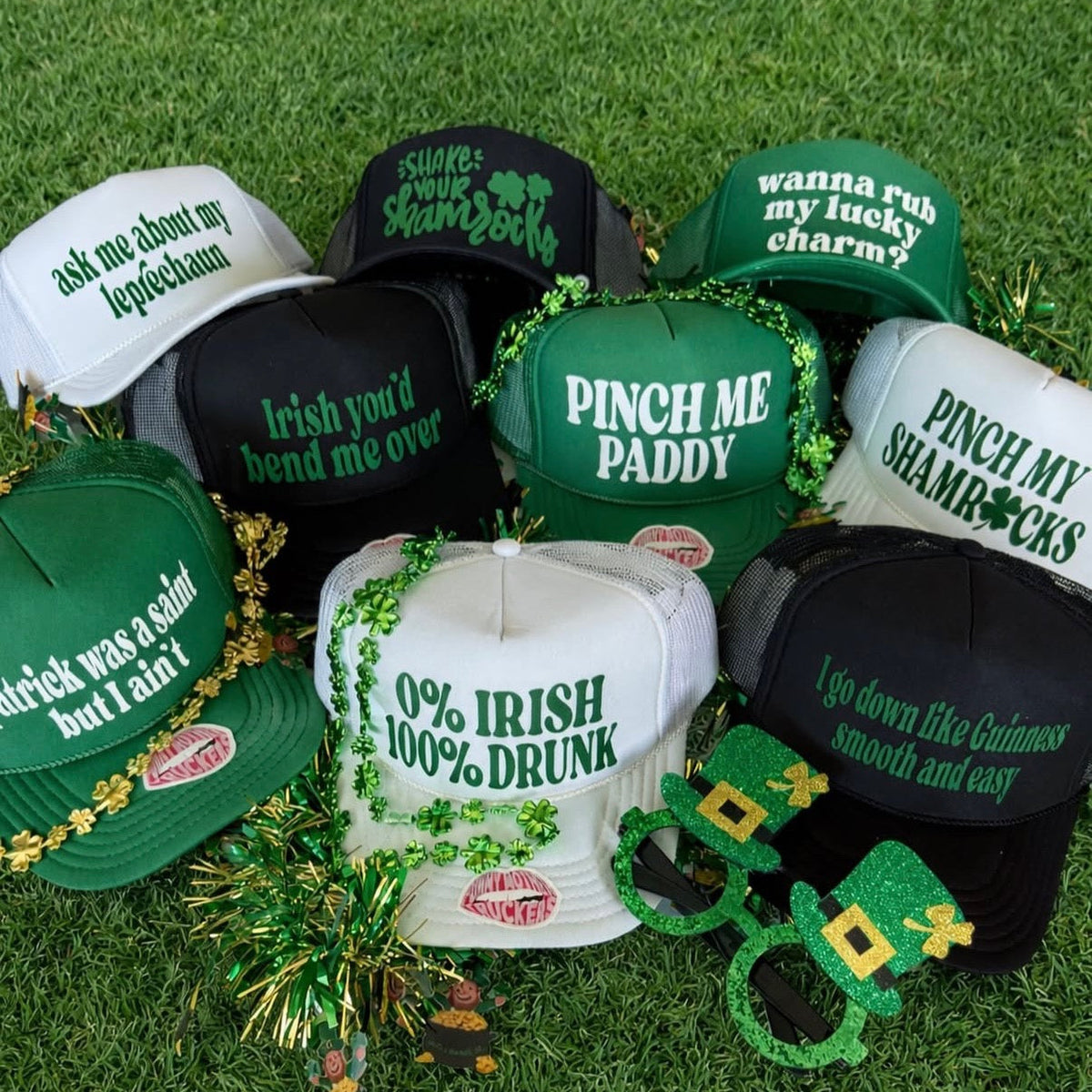 Collection of St. Patrick's Day-themed hats and accessories on grass