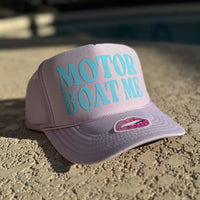 Purple cap with 'Motor Boat Me' text on a textured surface